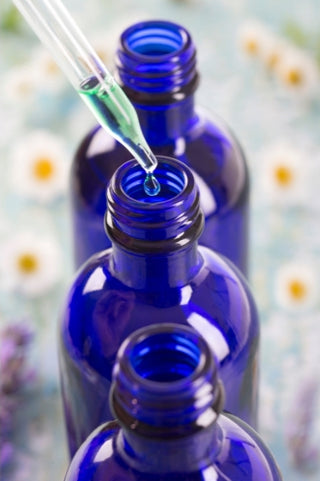 oil dropper and blue bottles
